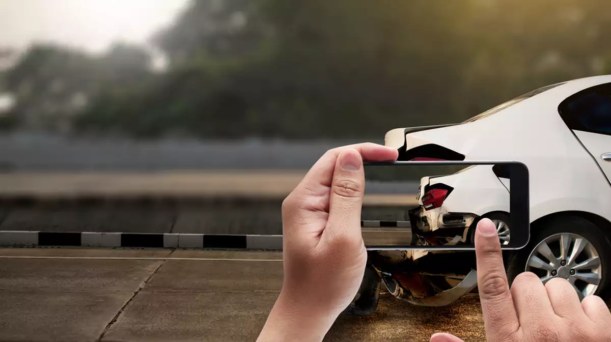 A driver photographs their car following a hit and run accident.